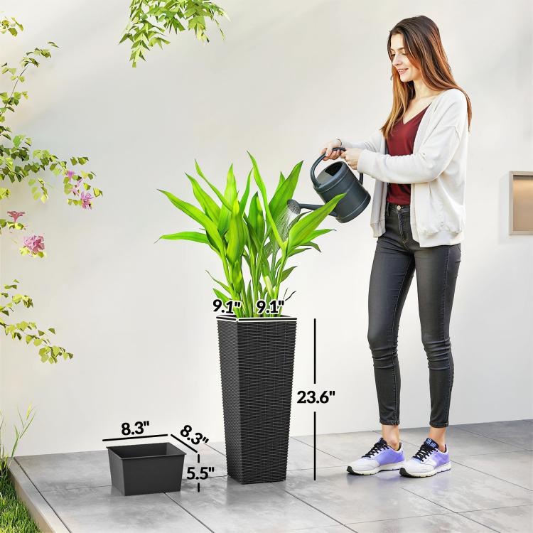 Black tall woven planter with drainage tray, shown next to a person
