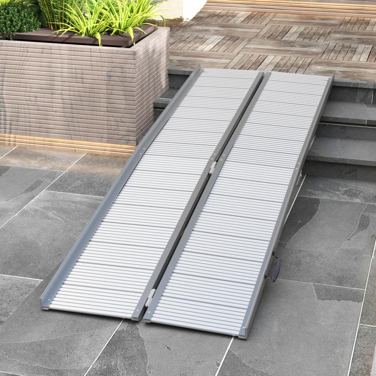 Doorway aluminum wheelchair ramp with ribbed grip panels and raised edges