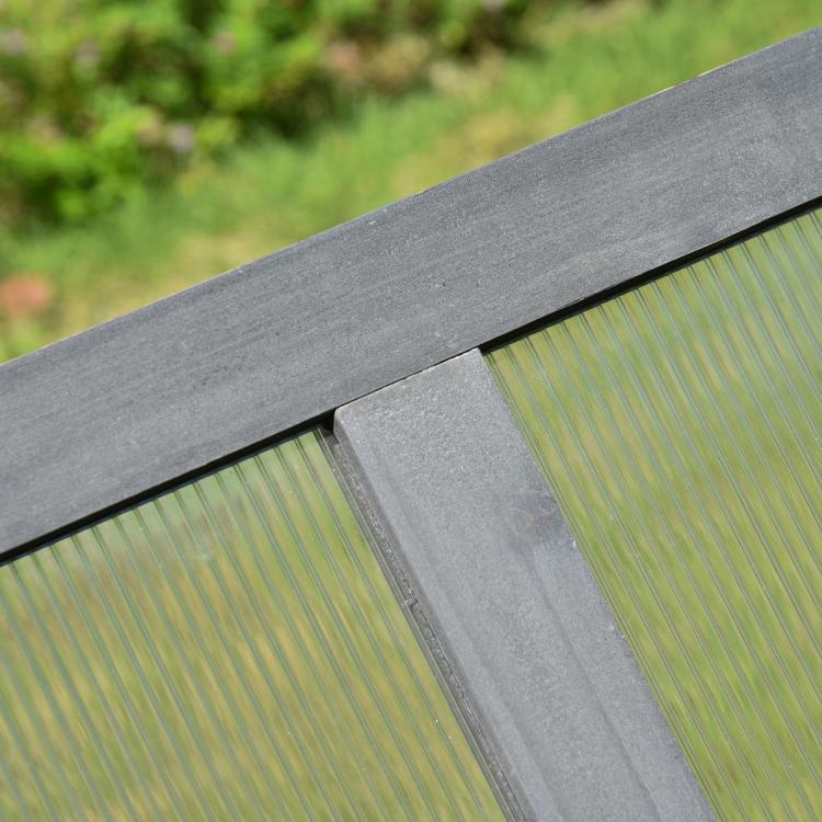 Gray wood frame corner with transparent polycarbonate panel and ridged glazing