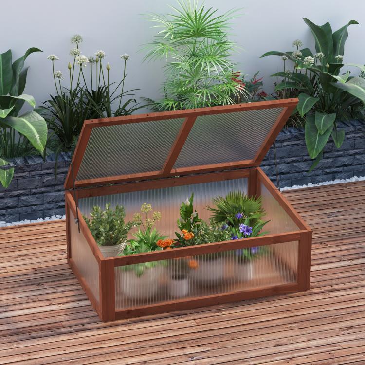 Mini wooden cold frame greenhouse with open lid, clear panels, and potted plants inside