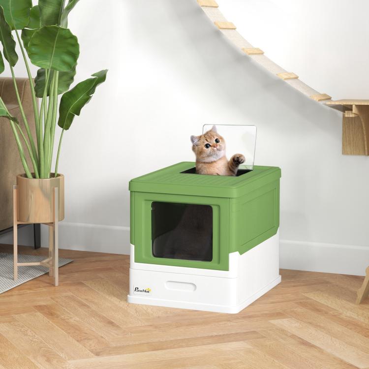 Enclosed green-and-white cat litter box with front window; cat on top