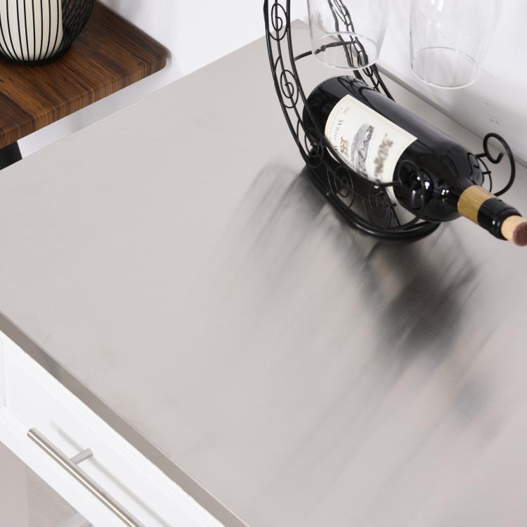 Stainless steel countertop being cleaned on a white kitchen island cart