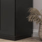 Black freestanding pantry cabinet with flat panel doors and wide base trim