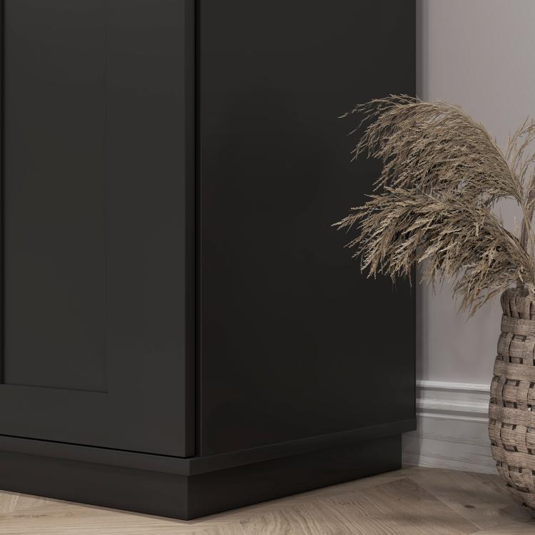 Black freestanding pantry cabinet with flat panel doors and wide base trim