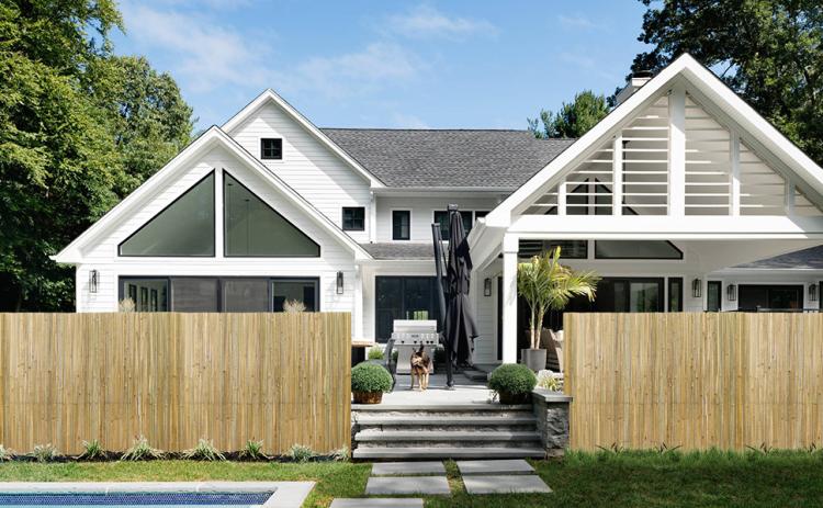 Natural bamboo privacy fence panels along a front yard walkway