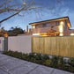 Natural bamboo privacy fence panel with vertical slats along an outdoor patio wall