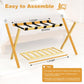 Bamboo luggage rack with X-shaped frame and black straps, with foldable base slats