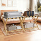 Bamboo luggage rack with black straps, holding a gray suitcase and a brown duffel bag