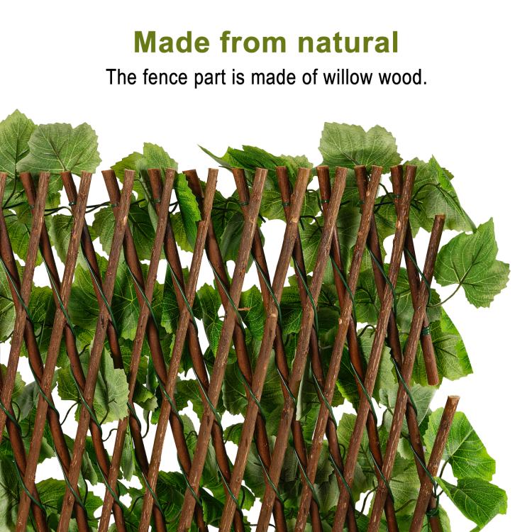 Green faux ivy leaves attached to brown willow-wood lattice fence panel