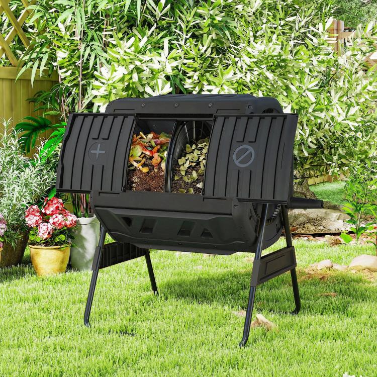 Black dual-chamber tumbling compost bin outdoors with both hatches open