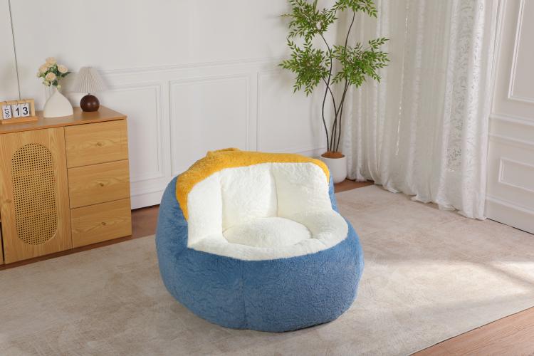 Oversized bean bag chair with blue faux fur and white inner cushion, yellow accent