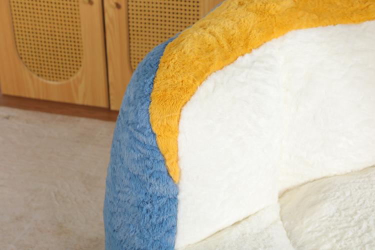 Oversized bean bag chair close-up with blue faux fur side and yellow-and-white seat