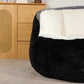 Oversized bean bag chair with black fuzzy outer and white padded backrest