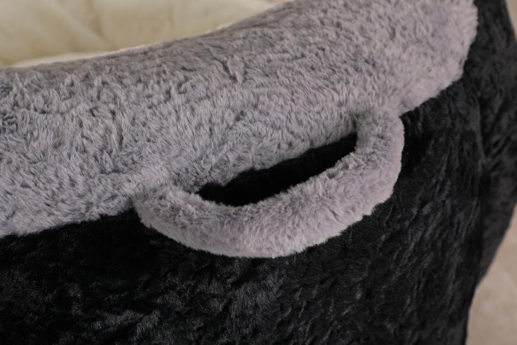 Close-up of gray faux fur trim and black side panel on bean bag chair
