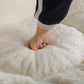 Person kneading soft white inner cushion of the bean bag chair