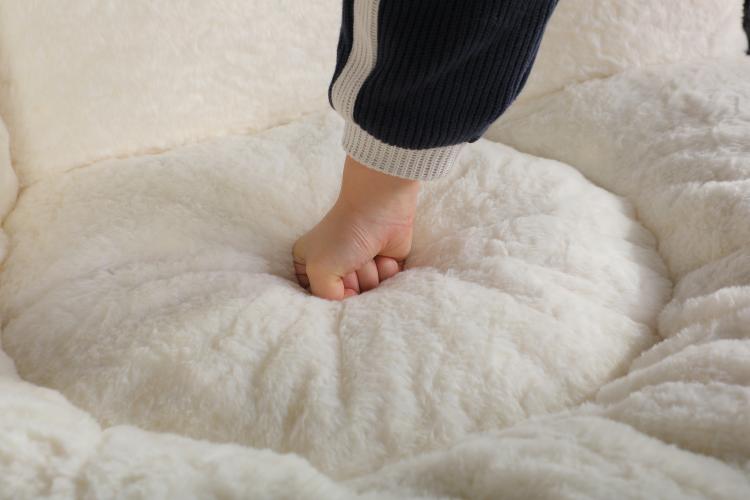 Person kneading soft white inner cushion of the bean bag chair