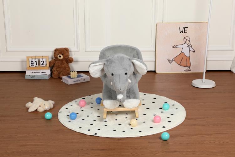 Grey plush elephant rocker seated on round play mat with colorful balls