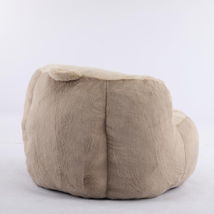 Faux fur bean bag chair, rounded low profile with side arms, light tan