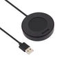 Round black charging puck with built-in dock and USB cable