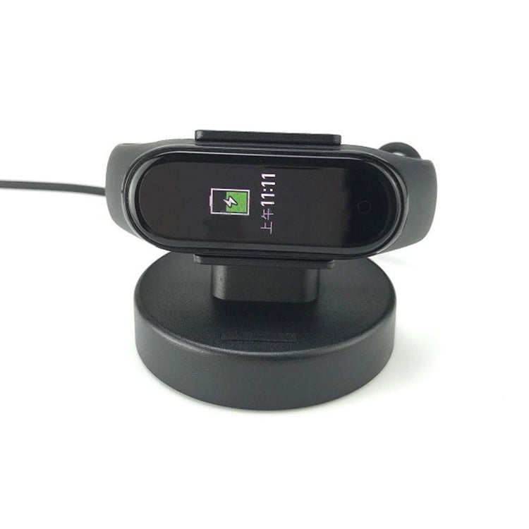 Black charging cradle dock showing screen charging indicator