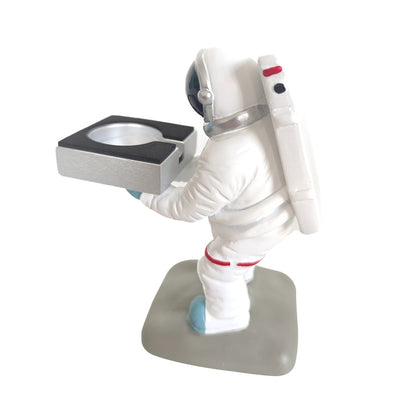 Astronaut-themed Apple Watch charging stand with figure holding a square dock