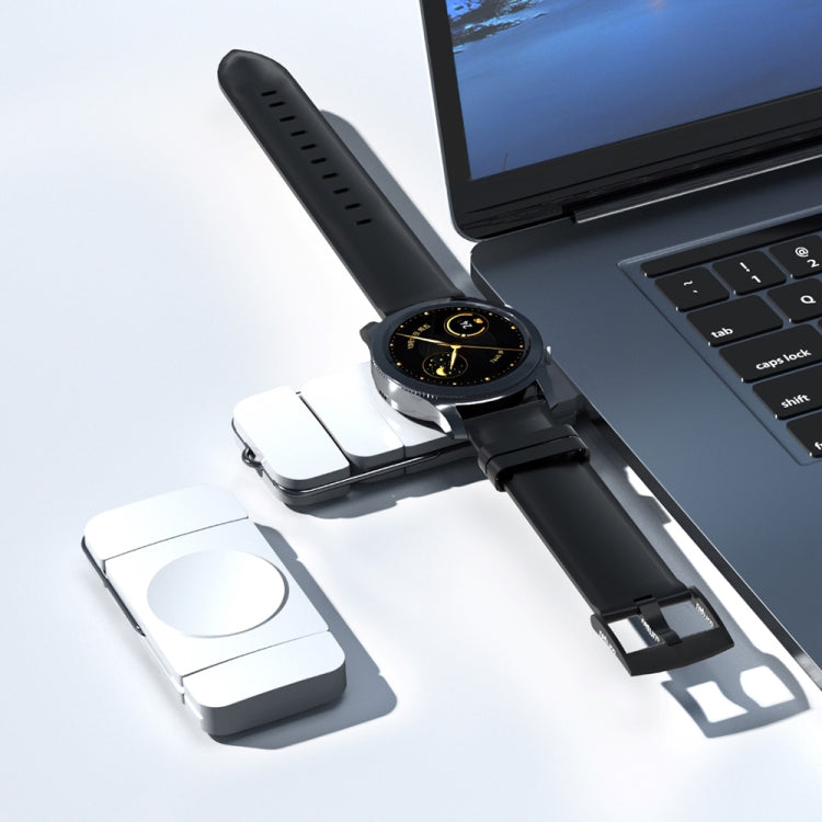 Black magnetic wireless charger dongle with round contact pad and watch stand