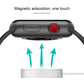 Black smartwatch charging puck with red control dial and upward charging airflow arrows