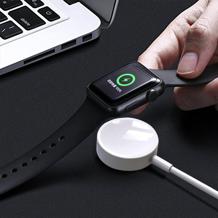 White magnetic charger puck with cable, ready for Apple Watch charging.