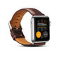 Brown leather watch band with polished metal buckle and stitched strap edge