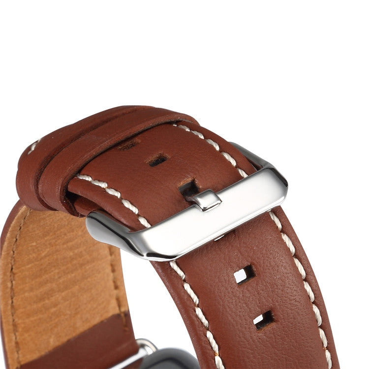 Denior leather watch band close-up, brown leather with silver buckle and stitched holes.