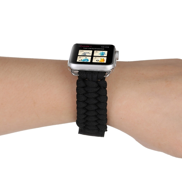 Black braided rope watch band on wrist with stainless buckle and black leather keeper