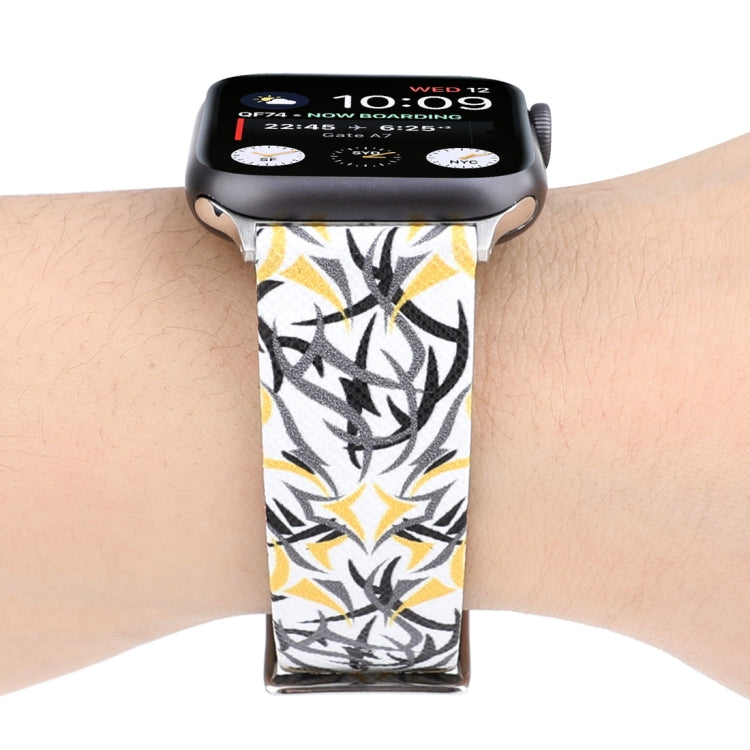Leather watch band with black-and-yellow thorn print; silver clasp and perforated strap