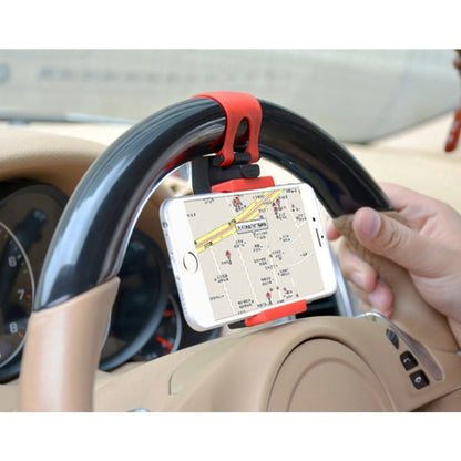 Car steering wheel phone bracket holding a smartphone with red strap and black mount