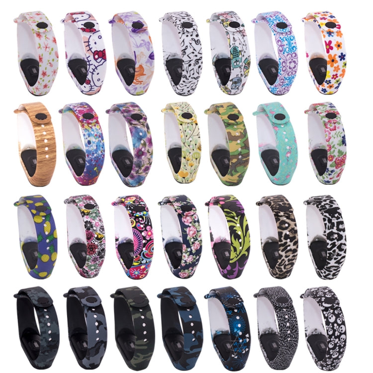 Assorted silicone watch bands with colorful patterns and white perforated straps for fitness tracker