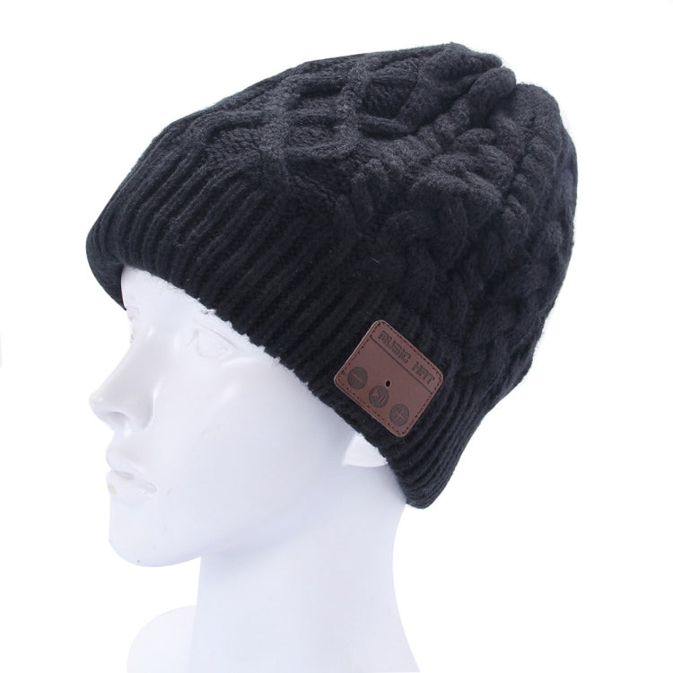 Black textured knit Bluetooth beanie hat on head form with brown control patch