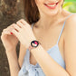 Rose gold mesh watch band on wrist; smartwatch with dark screen