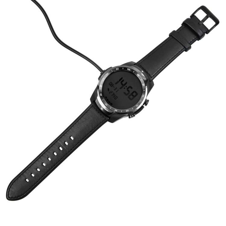 Black smartwatch with leather strap and charging puck cable