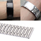 Stainless steel watch band on wrist with metal links; shows black and silver views