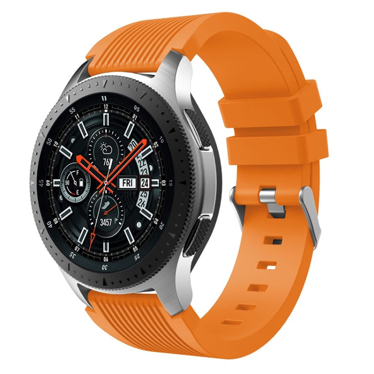 Orange silicone watch band with vertical grain ridges and perforated clasp holes