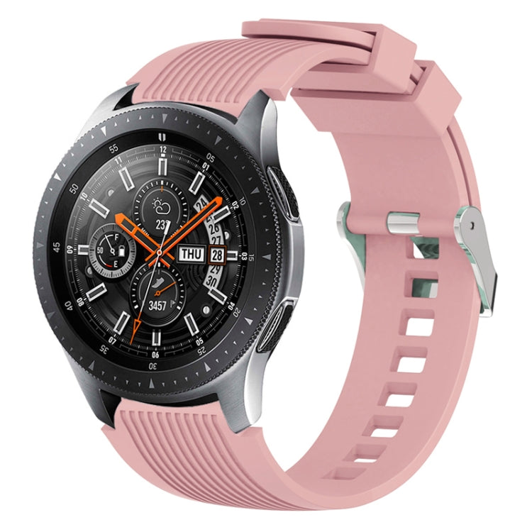 Pink silicone watch band with vertical grain ridges and side buckle holes