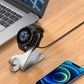 Silver/grey charging base holding a smartwatch with magnetic dock and USB cable