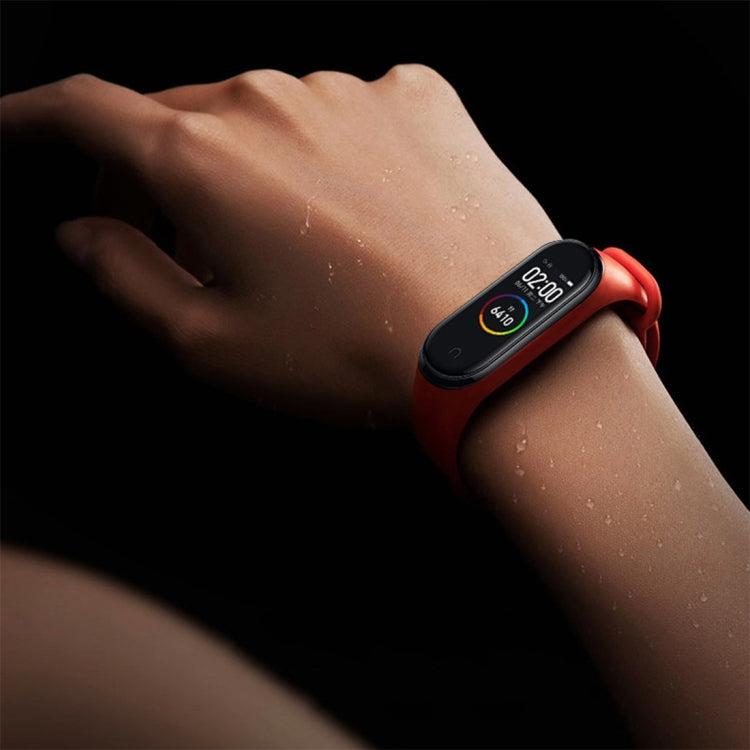 Soft TPU watch band in red on wrist, perforated sport strap