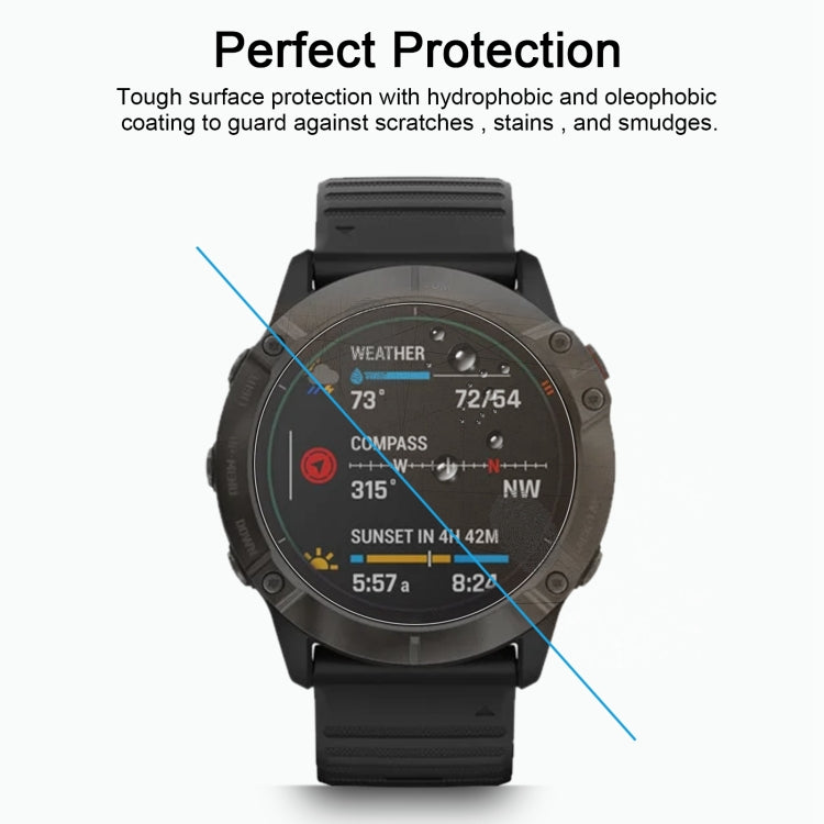 Black Garmin smartwatch wearing clear tempered glass screen protector over display