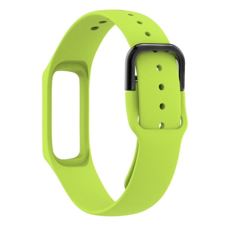 Green silicone watch band with metal spring bars and rectangular connector, angled view.