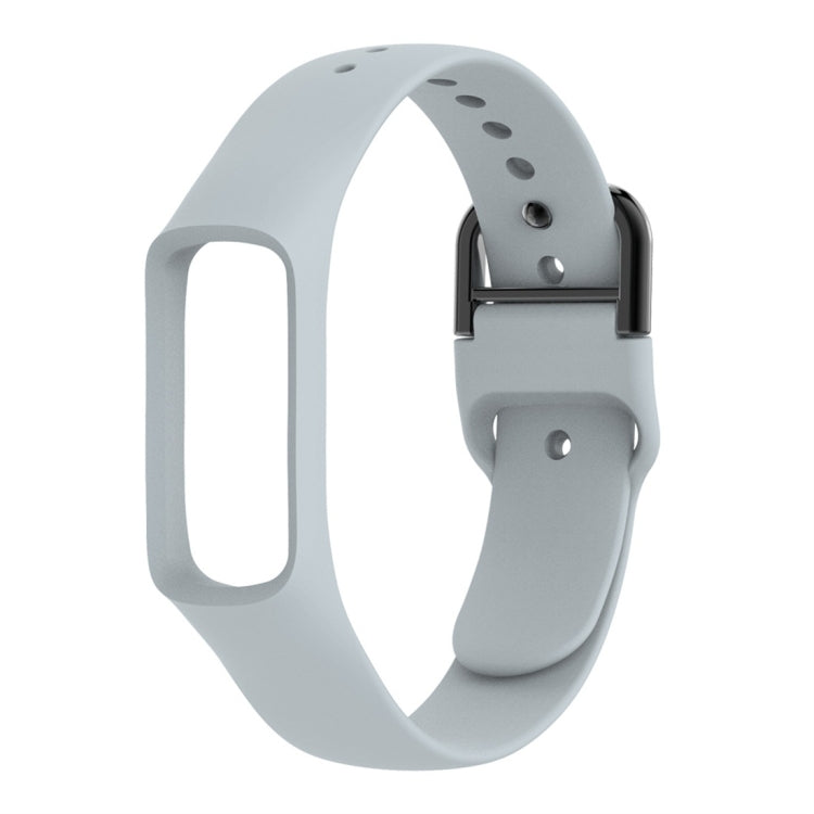 Gray silicone watch band with metal buckle and perforation holes for smartwatch fit.