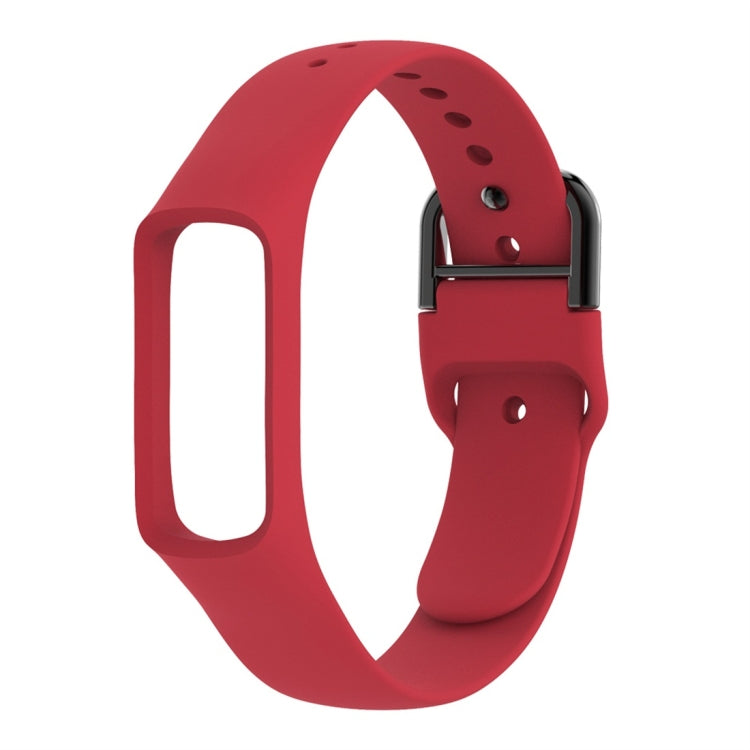 Red silicone smartwatch band with metal clasp and adjustment holes, side profile view.