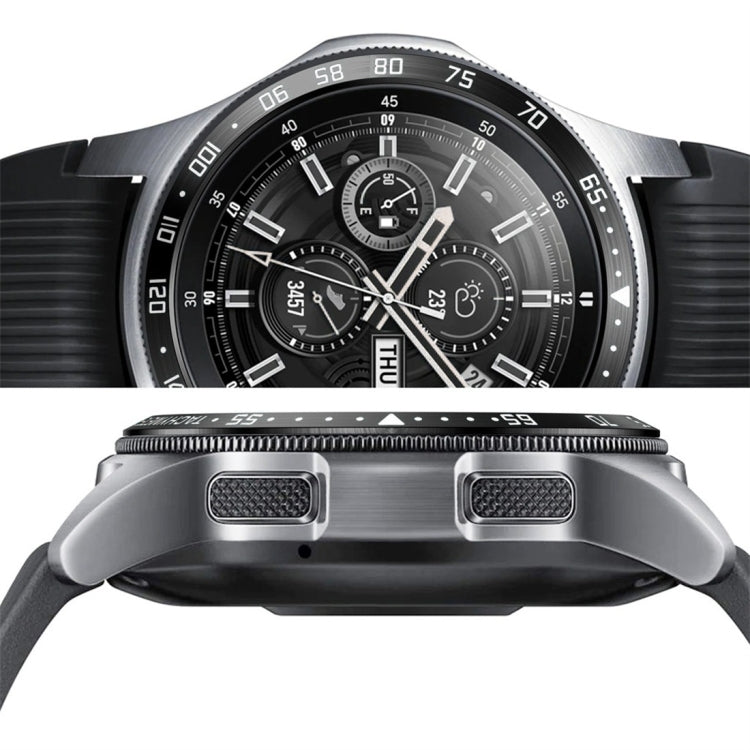 Steel protective watch frame with raised side openings on a black chronograph-style face