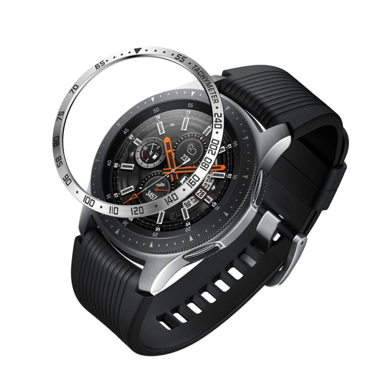 Black smartwatch with steel protective frame, orange accent dial, and black textured silicone band