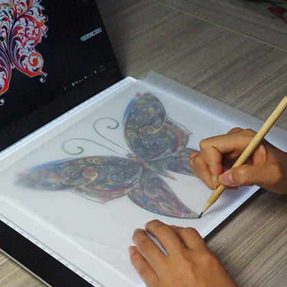 LED acrylic copy board with ruler edge; hands sketch on illuminated tracing surface