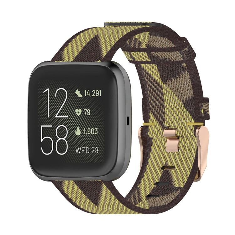 Woven nylon watch strap with yellow and dark camo stripe pattern, metal buckle.